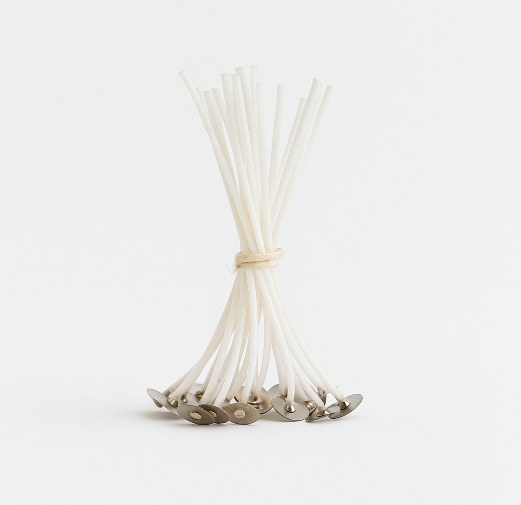 Pre-tabbed cotton wicks for White Cove refillable candle sand. A refill pack of white wicks with metal bases isolated on a white background for sustainable candle making