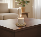 Minimalist home decor featuring White Cove's unscented vegetable-based candle sand burning in a simple glass jar, placed on a natural rope coaster in a bright, coastal-inspired lounge