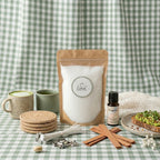 Sustainable morning wellness routine featuring White Cove UK's refillable candle kit. This lifestyle shot showcases the complete plant-based candle sand ecosystem, including dual wick options and Positivity fragrance oil, arranged next to a healthy breakfast aesthetic