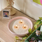 Pastel aesthetic room decor featuring White Cove UK plant-based candle sand. This lifestyle shot demonstrates how to reuse cute containers to create a custom multi-wick candle, styled alongside Y2K-inspired accessories and fresh plants for a personalized bedroom setup
