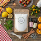 The complete Summer Fling sustainable candle making kit by White Cove UK styled in a cozy living room. This lifestyle shot showcases the complete plant-based candle sand ecosystem, including dual wick options, woven heat-guard coasters, and refreshing fragrance oil, beautifully arranged alongside home decor to promote a mindful aesthetic