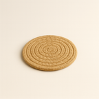 Minimalist, coastal-style woven rope coasters. A set of three heat-resistant mats on a plain, light background for safe candle styling by White Cove UK